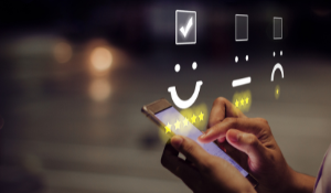 person leaving smiley face rating on touch screen phone