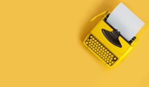 yellow typewriter on yellow background